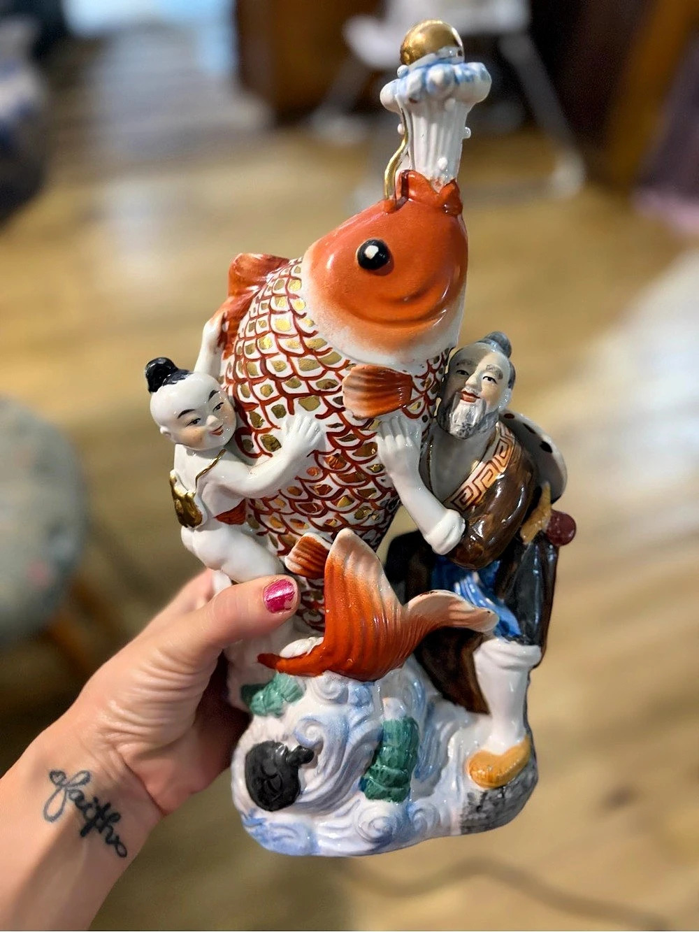Vintage hand-painted Chinese porcelain sculpture featuring a large red-orange k